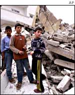 Palestinian children in the rubble of house