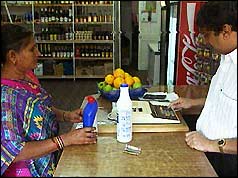 Ugandan Asian shopkeeper and customer