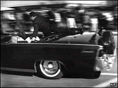 A secret serviceman jumps into Kennedy's car seconds after he was shot