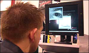A visitor to the trade fair experiments with iris recognition technology