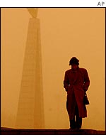 A woman walks through dust in Changchun, north-east China's Jilin Province