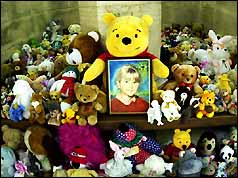 Cuddly toys surround a picture of murdered schoolgirl Sarah Payne at Guildford Cathedral 
