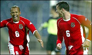 Robert Earnshaw rushes to congratulate goalscorer and captain Gary Speed after he gives Wales a ninth minute 1-0 lead