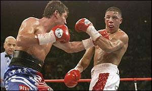 Oscar de la Hoya (left) hits Fernando Vargas with a left hook