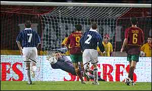 Scotland's keeper Rab Douglas save a penalty from Luis Figo