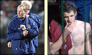 Scotland manager Berti Vogts and defender Christian Dailly walk off the pitch