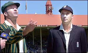 Australian captain Steve Waugh (left) spins the coin as his English counterpart Nasser Hussain watches