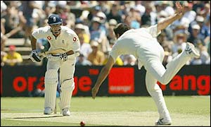 England's Michael Vaughan hits the ball past Jason Gillespie 