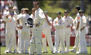 Michael Vaughan waits for the third umpire to decide if he was caught by Justin Langer