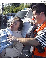 An injured woman is taken from the scene of the Jerusalem bus bombing