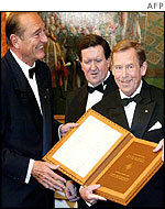 French President Jacques Chirac presents Mr Havel a copy of Nato's founding treaty
