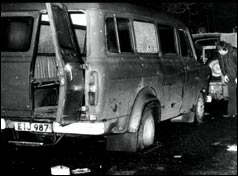 The minibus with back door flung open, windows smashed and bullet holes down the side