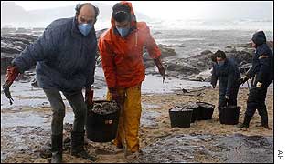 Volunteers clearing oil from beach