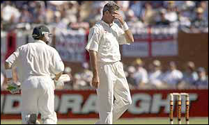 Andrew Caddick puts his head in his hands