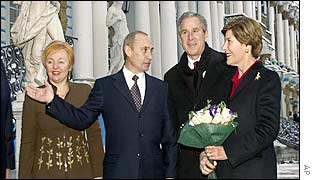 George and Laura Bush (right) are greeted by Vladimir Putin and his wife Lyudmilla