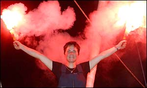 Ellen MacArthur lights flares in celebration after winning the Route du Rhum