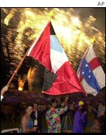 People hold up their national flags 
