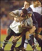 Fiji's Richard Nyholt is tackled by Scotland's Greame Beveridge