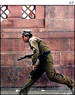 An Indian policeman runs for cover during the attack on the Indian Parliament in December 2001