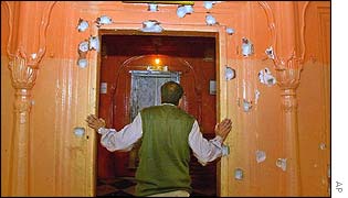 A temple official surveys the damage to the Raghunath temple