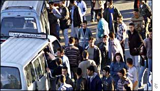 Syrians at a bus stop in Damascus