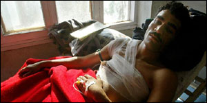 Indian policeman Shafkaf Hussein lies wounded following the shoot-out