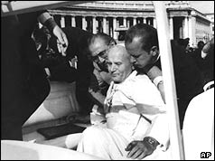 The injured Pope helped by aides in St Peter's Square