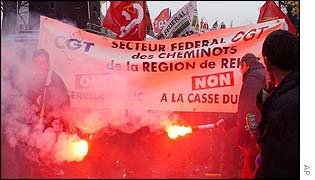 Protesters waving banners and lighting flares