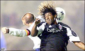 Rufus Brevett jumps for the ball with Hertha Berlin captain Stefan Beinlich