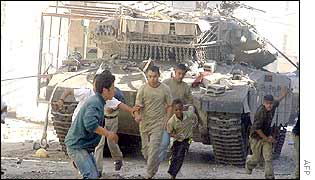 Palestinian youths and an Israeli tank in Jenin