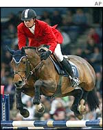 A showjumper and his horse clear a fence