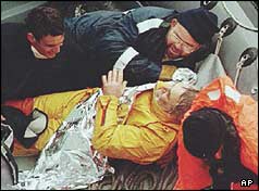 Tony Bullimore lying in the life raft with three rescuers