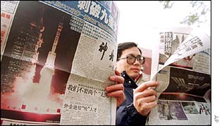 Chinese papers reporting space launch (AP)