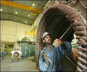 An Iraqi worker fixes a machine at al-Rashad