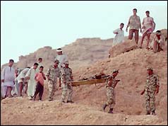 Soldiers carry gunman's body 