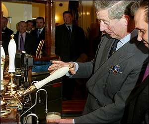Prince Charles pulling a pint at the pub in Poundbury, Dorset