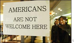 South Koreans pass by an anti-US banner at a restaurant in Seoul, 28 Nov. 2002