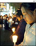 Holding candles in their hands, South Korean Christians pray for South Korean girls during a memorial service in the street of Seoul, South Korea, 
