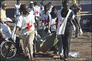Red Cross workers carry away one of the victims