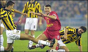 Liverpool's Steven Gerrard is tackled by a pair of Vitesse players