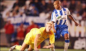 Alan Smith finds himself on the end of some strong challenges as the Malaga defenders mark him out as the danger player