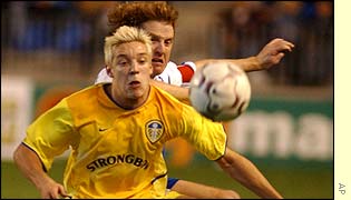 Leeds' Alan Smith shields the ball from Malaga's Mikel Roteta