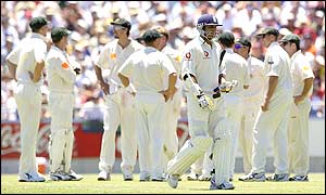 As Australia celebrate their second wicket England's Mark Butcher leaves the pitch after being run out