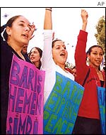 Turkish Cypriot girls hold banners reads: Peace now and Peace during a demonstration in Nicosia