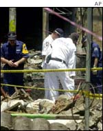 Police search through the remains of the Safari Club in Bali