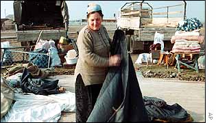 Chechen refugee packs-up her tent preparing to leave the refugee camp at Aki-Yurt