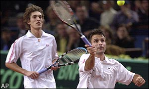 Fabrice Santoro plays a volley during the first set