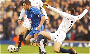 Birmingham's goal scorer Jeff Kenna breaks through the tackle from Darren Anderton