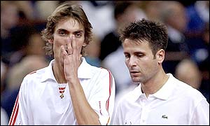Nicolas Escude and Fabrice Santoro of France discuss tactics