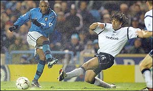 Nicolas Anelka of Manchester City battles with Bolton's Ivan Campo in the rain